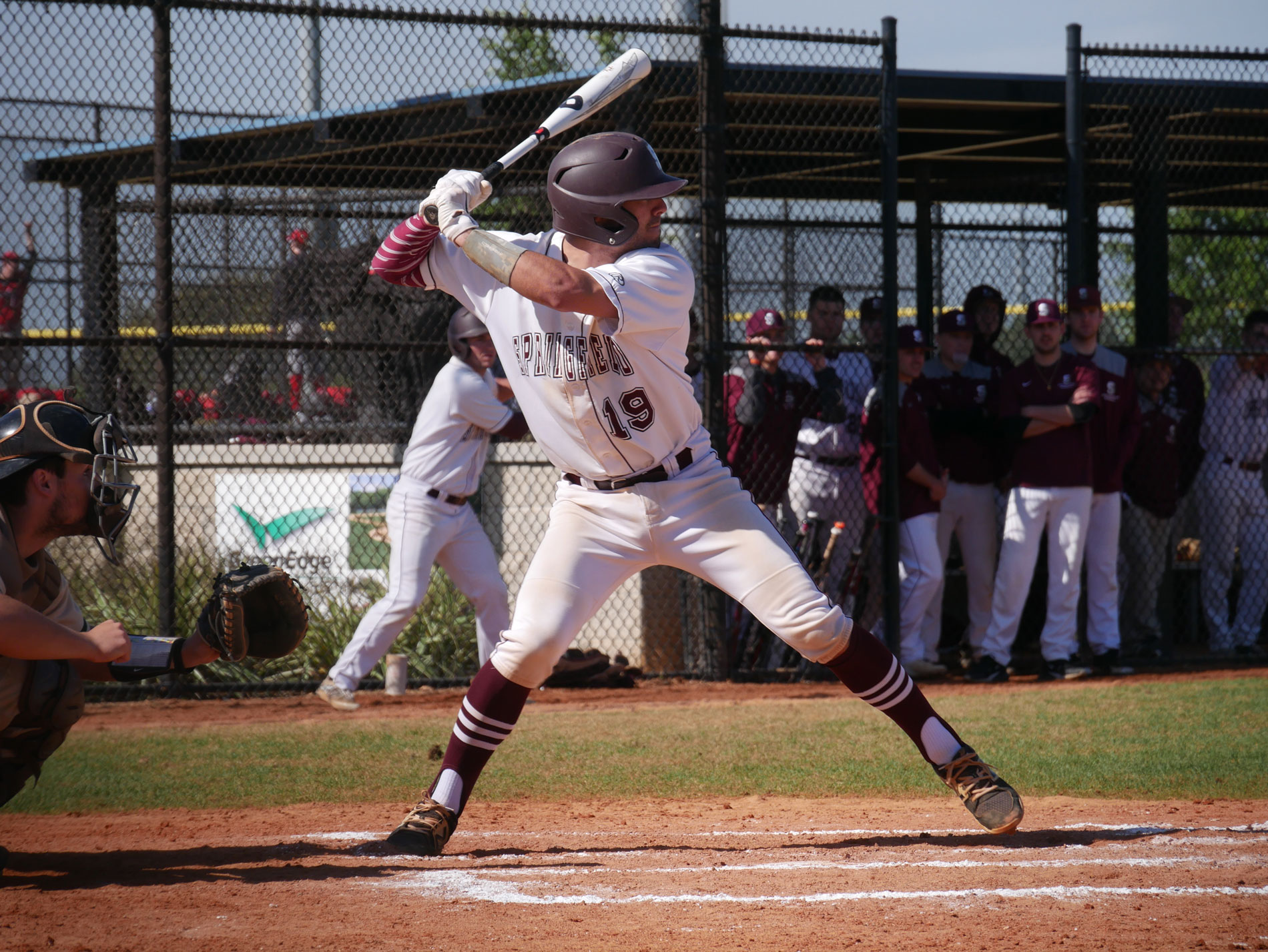 A baseball player prepares to swing the bat at Springfield College